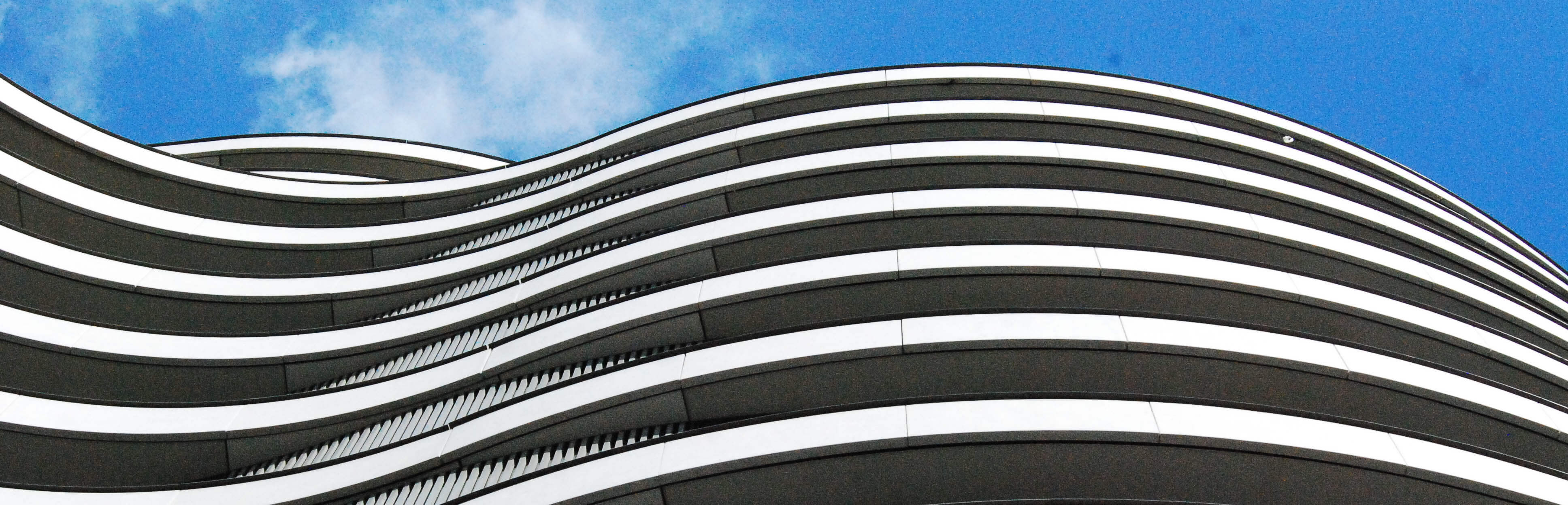 Contact Low Angle View Of Modern Building Against Blue Sky